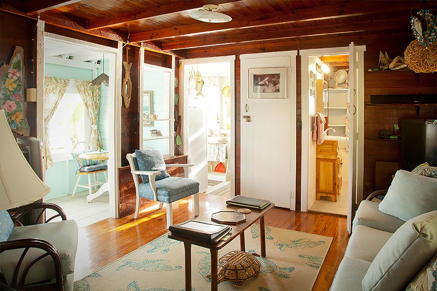 Open floor plan of living area offers wonderful light through the many windows, and breezy, fresh air keeps the cottage fresh.