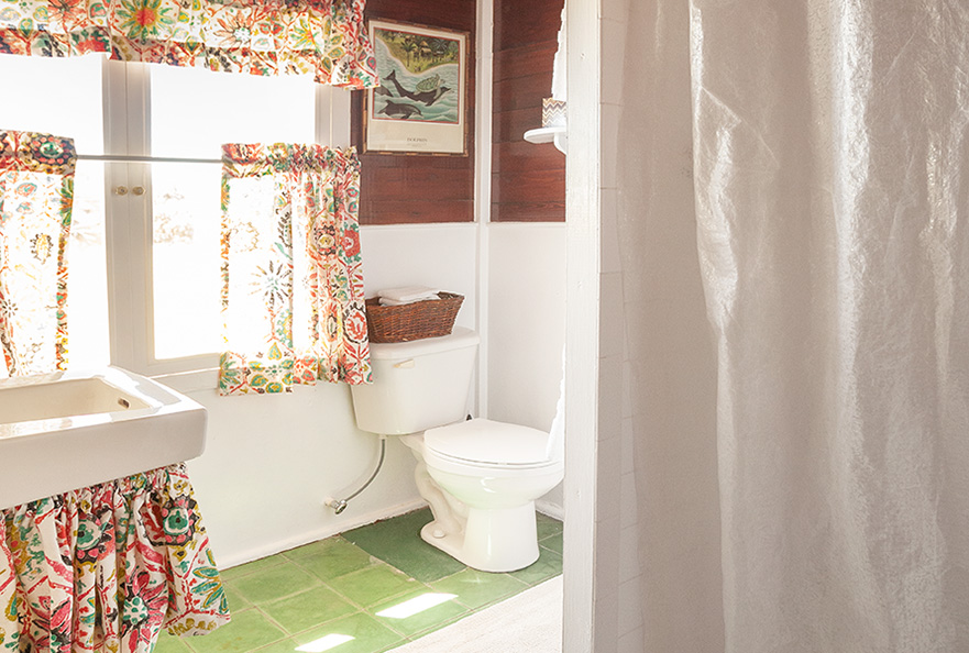 Seagrape Beach Cottage has a lovely Bahamaian decor bathroom with shower.