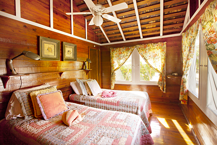 Bedroom number two features two twin beds and ceiling fan.